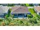 A stunning aerial view of a house showcasing a covered patio and landscaped backyard at 8668 Sundance Loop, Sarasota, FL 34238