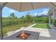 Inviting backyard with putting green, fire pit, and lush landscaping at 8668 Sundance Loop, Sarasota, FL 34238