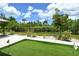 Well-maintained backyard featuring a putting green and mature landscaping at 8668 Sundance Loop, Sarasota, FL 34238