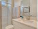 Bright bathroom features a white vanity, shower with glass door, and neutral wall color at 8668 Sundance Loop, Sarasota, FL 34238