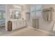 Bright bathroom featuring double sinks, plantation shutters, and a spacious layout at 8668 Sundance Loop, Sarasota, FL 34238