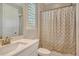 Bathroom featuring modern vanity, shuttered window, and a shower with a patterned curtain at 8668 Sundance Loop, Sarasota, FL 34238