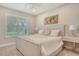 Cozy bedroom featuring natural light from shuttered windows and neutral tones at 8668 Sundance Loop, Sarasota, FL 34238