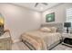 Neutral bedroom with a plush bed, ceiling fan, and a golf-themed art piece on the wall at 8668 Sundance Loop, Sarasota, FL 34238