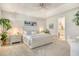 Serene main bedroom with a tray ceiling, soft lighting, and an ensuite bathroom at 8668 Sundance Loop, Sarasota, FL 34238