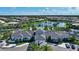 A stunning clubhouse with a pool and manicured landscaping offers luxury amenities at 8668 Sundance Loop, Sarasota, FL 34238