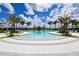 Resort-style community pool with ample lounge seating, lush landscaping, and a serene atmosphere at 8668 Sundance Loop, Sarasota, FL 34238