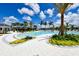 Beautiful pool area with comfortable lounge chairs, palm trees, and well-manicured landscaping at 8668 Sundance Loop, Sarasota, FL 34238