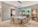 Elegant dining room with a modern light fixture, stylish table setting, and a view of the backyard at 8668 Sundance Loop, Sarasota, FL 34238