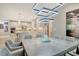 Bright dining room featuring a modern chandelier with open access to the kitchen with stainless steel appliances at 8668 Sundance Loop, Sarasota, FL 34238