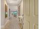 Bright foyer featuring wood-look floors, neutral paint, and an open view into the main living area at 8668 Sundance Loop, Sarasota, FL 34238