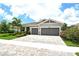 Well-maintained single-Gathering home featuring mature landscaping, a paver driveway, and a two-car garage at 8668 Sundance Loop, Sarasota, FL 34238