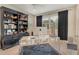 Bright home office with a stylish desk, ample shelving, and large windows for natural light at 8668 Sundance Loop, Sarasota, FL 34238