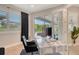 Home office featuring a clear desk and a view through glass doors to an outdoor seating area at 8668 Sundance Loop, Sarasota, FL 34238
