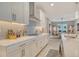 Contemporary kitchen featuring white cabinets, subway tile backsplash, stainless appliances, and quartz countertops at 8668 Sundance Loop, Sarasota, FL 34238