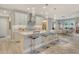 Open concept kitchen with white cabinets, modern fixtures, a center island, and bar stool seating at 8668 Sundance Loop, Sarasota, FL 34238