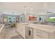 Open-concept kitchen with an island, stainless steel appliances, and a seamless flow into the dining and living areas at 8668 Sundance Loop, Sarasota, FL 34238