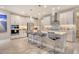 Modern kitchen with white cabinets, stainless steel appliances, a stylish island, and pendant lighting at 8668 Sundance Loop, Sarasota, FL 34238