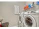 Laundry room featuring a modern washer and dryer set, plus wire shelving at 8668 Sundance Loop, Sarasota, FL 34238