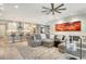 Bright and airy living room with modern decor, a ceiling fan, and an open floor plan to the kitchen at 8668 Sundance Loop, Sarasota, FL 34238