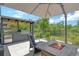 An outdoor kitchen and firepit offer the perfect setup for enjoying evenings on the patio at 8668 Sundance Loop, Sarasota, FL 34238