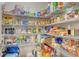 Organized walk-in pantry stocked with a wide variety of food and household items at 8668 Sundance Loop, Sarasota, FL 34238