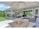 The spacious patio offers a dining area, lounge seating, a TV, a built-in BBQ, a hot tub, and a lovely view at 8668 Sundance Loop, Sarasota, FL 34238