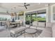 This spacious outdoor living area offers a lounge area, dining space, and TV, ideal for entertaining or relaxation at 8668 Sundance Loop, Sarasota, FL 34238