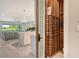 View of a wine cellar through a glass door, leading into a living space with an open floor plan at 8668 Sundance Loop, Sarasota, FL 34238