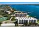 Picturesque aerial view featuring waterfront condominiums, docks, and vibrant landscaping at 8735 Midnight Pass Rd # 602B, Sarasota, FL 34242