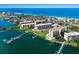Panoramic aerial showcasing beachfront condos, boat docks, and lush coastal scenery at 8735 Midnight Pass Rd # 602B, Sarasota, FL 34242