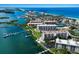 Beautiful aerial view of beachfront condos with private boat docks and ocean views at 8735 Midnight Pass Rd # 602B, Sarasota, FL 34242