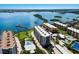Scenic aerial view of waterfront condos, showcasing a swimming pool, tennis court, and boat docks at 8735 Midnight Pass Rd # 602B, Sarasota, FL 34242