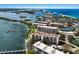 Stunning aerial shot of condos with boat docks, beautiful landscaping, and tennis courts at 8735 Midnight Pass Rd # 602B, Sarasota, FL 34242