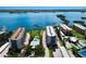 Expansive aerial view showcasing waterfront condominiums, a private pool, and beautifully landscaped grounds at 8735 Midnight Pass Rd # 602B, Sarasota, FL 34242