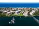 Breathtaking aerial view of coastal condominiums, a pristine beach, and boat docks along the waterfront at 8735 Midnight Pass Rd # 602B, Sarasota, FL 34242