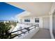 Bright condo balcony with railing and stunning views of the ocean and lush landscaping at 8735 Midnight Pass Rd # 602B, Sarasota, FL 34242