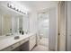 Clean bathroom with a large vanity, a bright vanity mirror, and access to an additional toilet and shower at 8735 Midnight Pass Rd # 602B, Sarasota, FL 34242