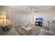 Comfortable bedroom with a ceiling fan, a bright TV, and closet space for ample storage at 8735 Midnight Pass Rd # 602B, Sarasota, FL 34242