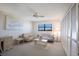 Cozy bedroom with a ceiling fan, a pastel color palette, and plenty of closet space for storage at 8735 Midnight Pass Rd # 602B, Sarasota, FL 34242