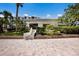 Exterior of the community clubhouse featuring well-manicured landscaping at 8735 Midnight Pass Rd # 602B, Sarasota, FL 34242