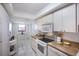 Charming kitchen with white appliances, a breakfast nook, and ample counter space for meal preparation at 8735 Midnight Pass Rd # 602B, Sarasota, FL 34242