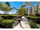 Walking path through lush landscaped grounds leading to condo buildings at 8735 Midnight Pass Rd # 602B, Sarasota, FL 34242