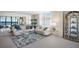 Bright living room with water views, plush seating, and mirrored wall reflecting the natural light at 8735 Midnight Pass Rd # 602B, Sarasota, FL 34242