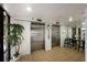 Condo lobby featuring elevators, tiled floors, a plant and a seating area at 8735 Midnight Pass Rd # 602B, Sarasota, FL 34242