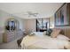 Tranquil main bedroom with balcony views, a neutral color palette, and plenty of natural light at 8735 Midnight Pass Rd # 602B, Sarasota, FL 34242