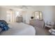 Spacious main bedroom with a dresser and mirror providing ample storage and an airy feel at 8735 Midnight Pass Rd # 602B, Sarasota, FL 34242