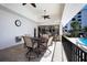Outdoor patio with ceiling fans, dining tables and grill overlooking community pool at 8735 Midnight Pass Rd # 602B, Sarasota, FL 34242