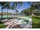 Recreational shuffleboard courts adjacent to a tennis court offer fun activities in a welcoming community setting at 8735 Midnight Pass Rd # 602B, Sarasota, FL 34242