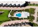 Aerial view of community pool and well landscaped grounds between condo buildings at 8735 Midnight Pass Rd # 602B, Sarasota, FL 34242